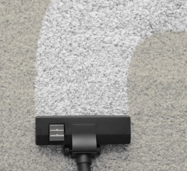 Vacuum cleaner removing dirt from carpet